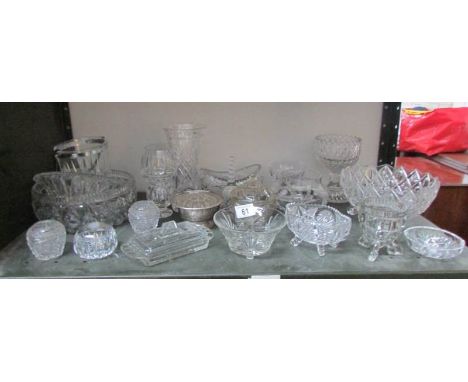 A shelf of assorted glass ware