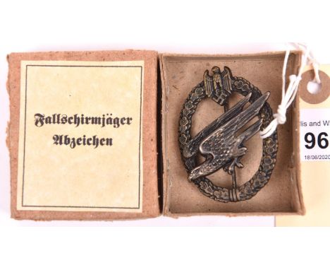 A Third Reich Army Parachutist badge, flat-back wreath with flush rivets and hollow-back eagle. GC. In its card box with prin