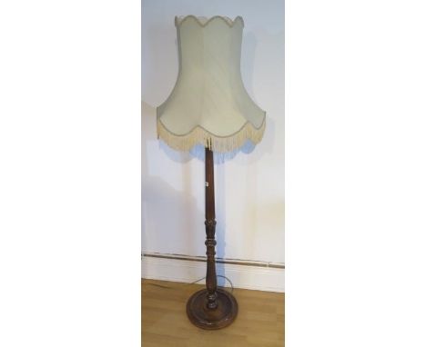 A mahogany standard lamp and shade in good condition 