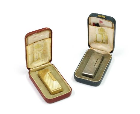 Two Dunhill lighters, both with engine turned decoration, one with engraved initials, 6.5cm long, both with cases (2)Conditio