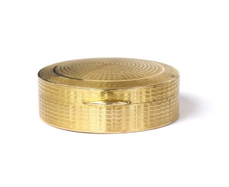 A 9ct gold mirrored compact, of circular form with engine turned decoration, mirror to the underside of the lid, and engraved