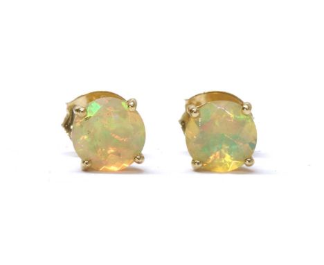 A pair of gold single stone opal stud earrings, with a circular mixed cut opal, approximately 6.0mm, claw set to post and but