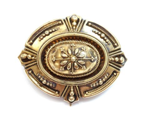 A Victorian archaeological revival Etruscan style shield form brooch, c.1870, with a raised oval boss, decorated with applied
