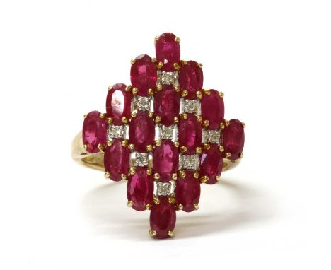 A 9ct gold ruby and diamond ring, the lozenge shaped head claw set with a lattice of oval mixed cut rubies and eight cut diam