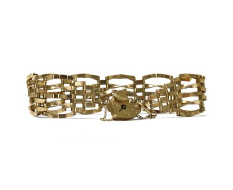A 9ct gold gate bracelet, with twisted and plain links, to heart shaped padlock clasp and safety chain, London, 11.73gConditi