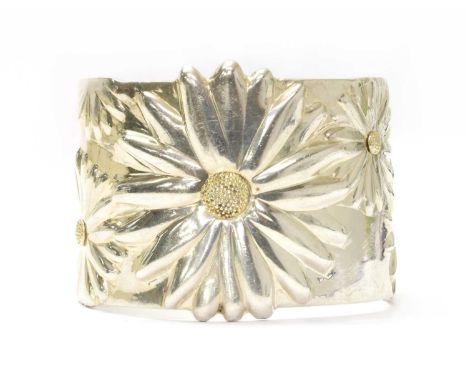 A silver daisy torque cuff bangle, by Tiffany &amp; Co., with gilding to the centres of the daisies, marked Tiffany &amp; Co.