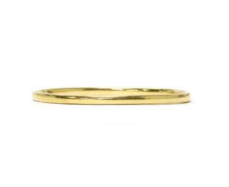 An Italian gold hollow hinged oval bangle, with concealed box clasp, marked 750, Italian official national marks 1968 to pres