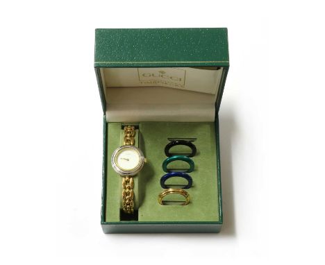A ladies' gold plated Gucci quartz bracelet watch, model no. 11/12.2, with a white dial, sword hands, integral link bracelet 