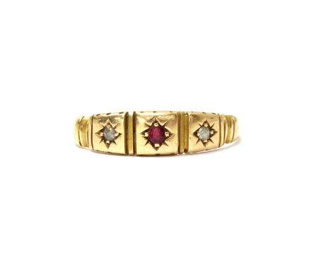 A 15ct gold ruby and diamond three stone ring, with a round mixed cut ruby with a rose cut diamond at each side, all star set