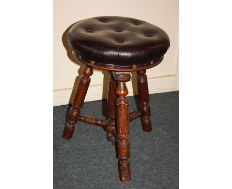 An adjustable piano stool with button upholstered circular leather top, on turned supports