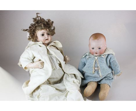 An Armand Marseille bisque head doll of a baby marked AM Germany, with soft body and composite hands, 41cm, together with a D