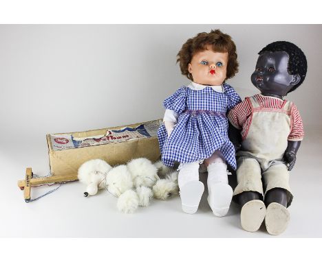 A Pelham puppet of a white poodle, together with two plastic dolls, largest 52cm