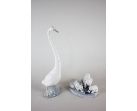 A Lladro porcelain figure group of three polar bears, together with a Nao porcelain figure of a swan, 33cm high