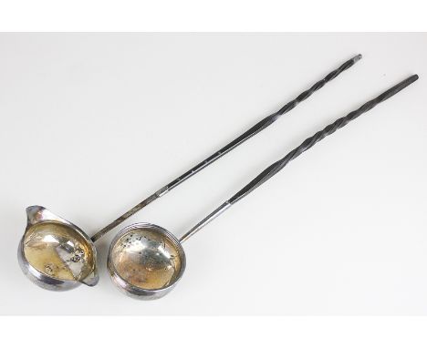 A Georgian silver punch ladle with twin spouted bowl and whalebone handle, and another similar punch ladle with circular bowl