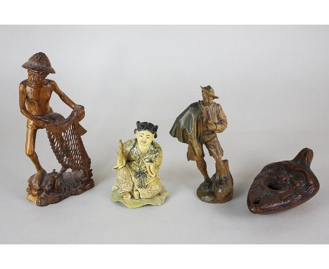 A resin figure of a Japanese okimono, two carved wooden figures and a Greek oil lamp