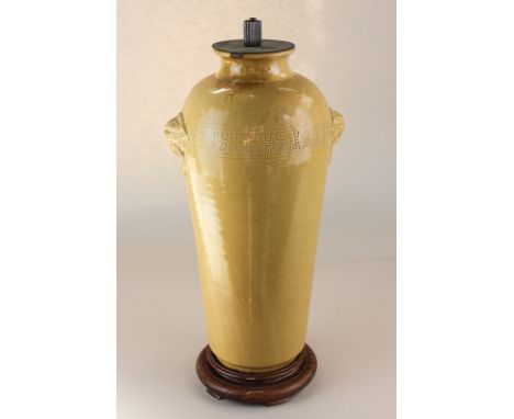 A Chinese pottery vase, now as a table lamp, with overlaid Fo dog ring lugs and incised character mark border, 44cm high