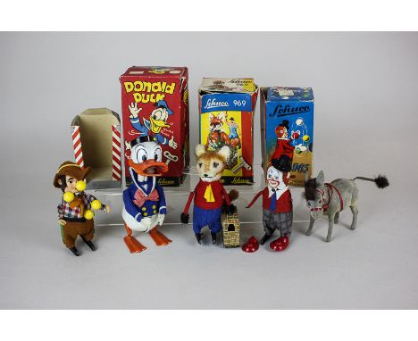 Four Schuco clockwork tin plate and plush toys comprising Donald Duck, fox carrying a goose and two juggling figures, all box