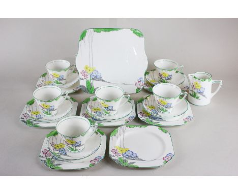 An Art Deco Heathcote best bone china tea set in the Lea pattern, comprising six teacups, saucers, side plates, a milk jug an