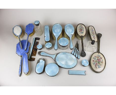 A collection of silver and enamel dressing table brushes and mirrors, including lids, jars and tools, (enamel in poor conditi