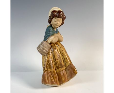 Lovely Gres finish figurine of girl holding basket with her arms crossed. Lladro backstamp. Artist: Salvador DebonIssued: 197