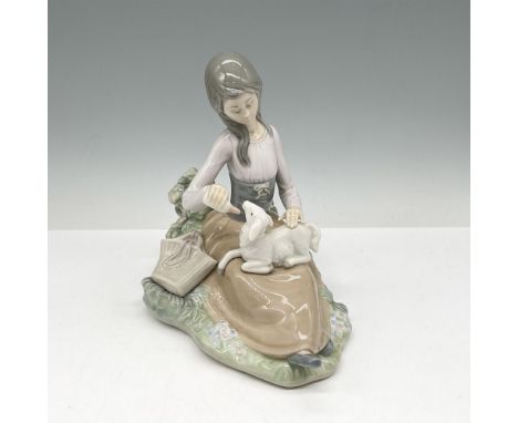 Glossy figure of a young girl bottle feeding a sheep. Lladro backstamp. This item has its original box: 7.5"L x 12"W x 6"H. A