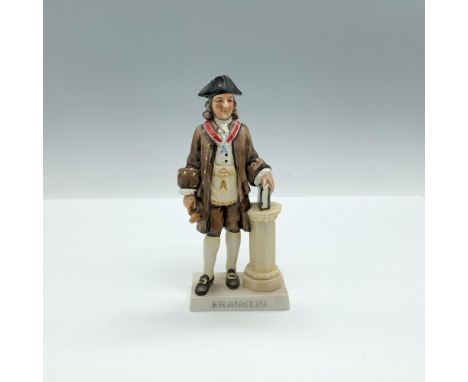 A hand painted matte sculpture of the famous American figure, dressed in brown colonial clothing and holding a gavel and book