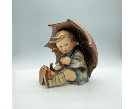 A matte hand painted figure of a young girl in a blue dress and orange pigtail bows, shielding herself from the rain under a 