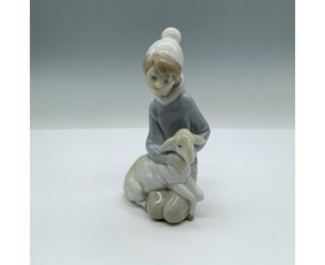 This figurine is part of the Childrens Nativity scene. Glossy finish; Lladro backstamp. Artist: Juan HuertaIssued: 1969-2001D