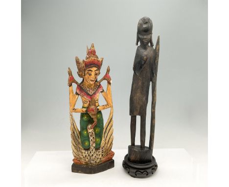 Thai dancer colored in red, green and black 12.5"H and dark wood carved African statue holding staff 13.5"H. This item has a 