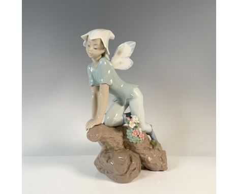 A glossy figure of a fairy kneeling on a flower-adorned branch. The first Annual Edition of the Lladro Privilege Collection i