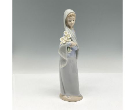 Glossy finish figure of serene girl with head scarf holding a grouping of white calla lilies. Lladro backstamp. This item has