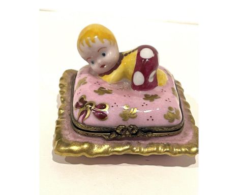 Adorable blonde Baby on decorative pink with 24k gold accenting Pillow. This Porcelain mini captures innocence and sweetness 