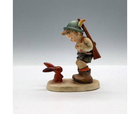 A matte figure of boy carrying a rifle over his shoulder while he is having a conversation with a small red rabbit. Goebel ba