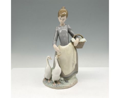 Glossy figural walking and feeding ducks. Colored in gray, white and tan. Lladro backstamp. This item has its original box: 7