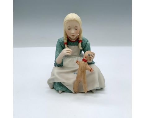 Hand painted porcelain figurine of a girl mending a doll. Cybis mark on the bottom. Issued: 20th c. Dimensions: 3.75"L x 3.75