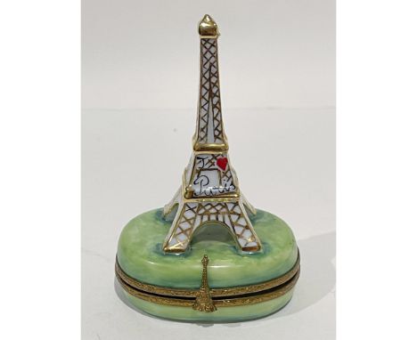 Oui, oui. Skillfully crafted 24k gold accented white hand painted Limoges Eiffel Tower with red heart and Paris atop soft gre