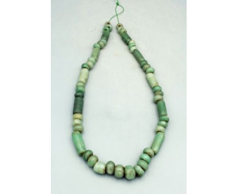 A strand of gorgeous Maya jade beads from Mexico, ca. 250 - 600 AD. The strand is 22 in. long and is comprised of beautifully