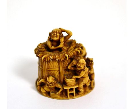 A Japanese carved ivory netsuke, Meiji period, depicting figures and demons bathing, signed to base 