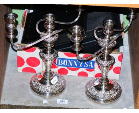 A pair of silver plated three light candelabra; together with various boxed flatware 