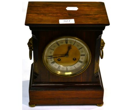A rosewood striking mantel clock, circa 1900, with drop ring lion mask handles 