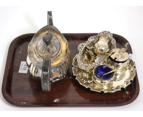 A silver teapot; a small silver salver or card tray; a three piece cruet set; and a pierced dish 