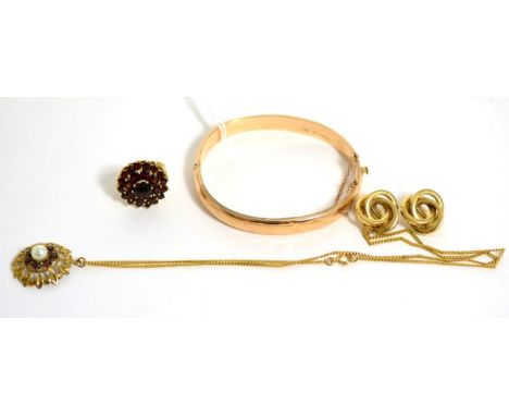 A 9 carat gold bangle, a pair of knot earrings, a garnet ring and a garnet pendant  Bangle - 8.65g gross. Knot earrings - 3.8