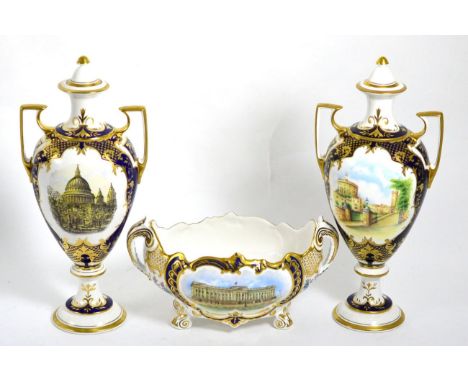 Three Spode Royal commemorative pieces comprising two similar urns and covers, one depicting St Paul's Cathedral, the other W