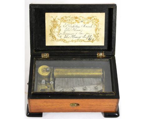A small 19th century music box playing four airs, with tune sheet to inside of cover 