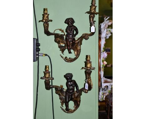 A pair of gilt and patinated twin-light wall lights, late 19th century, with foliate sconces and branches surmounted by two c