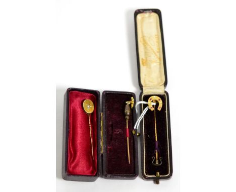 A diamond and ruby stick pin, a ruby stick pin and a seed pearl stick pin Diamond and ruby stick pin - 2.30g gross. Ruby stic