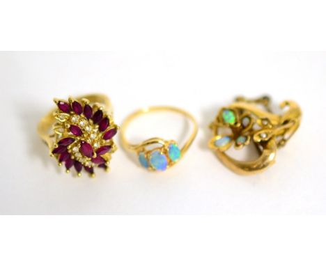 A 14 carat gold opal ring, an opal and seed pearl brooch and a ruby cluster ring, stamped '585' (3)11.3g gross