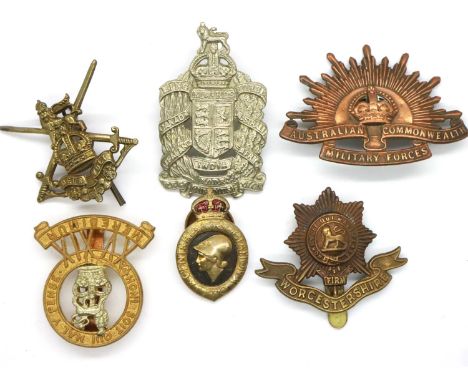 A collection of British WWI regimental cap badges, including King Edwards Horse Yeomanry (Colonial), Worcester Regiment and o