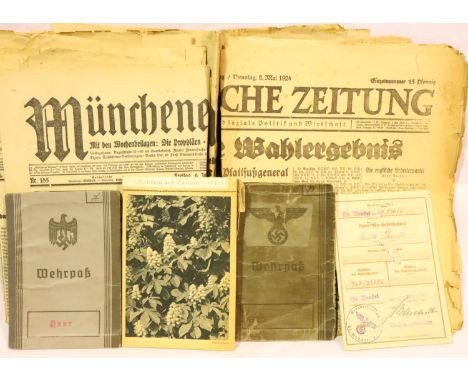 A collection of WWII German documents including 1920s-1930s newspapers and a quantity of Wehspass. P&amp;P Group 2 (£18+VAT f