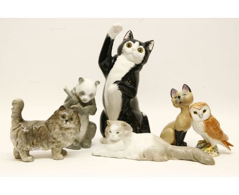 A quantity of ceramic cats, to include Royal Doulton model, Wade, Lladro, a Beswick owl and a Lladro panda